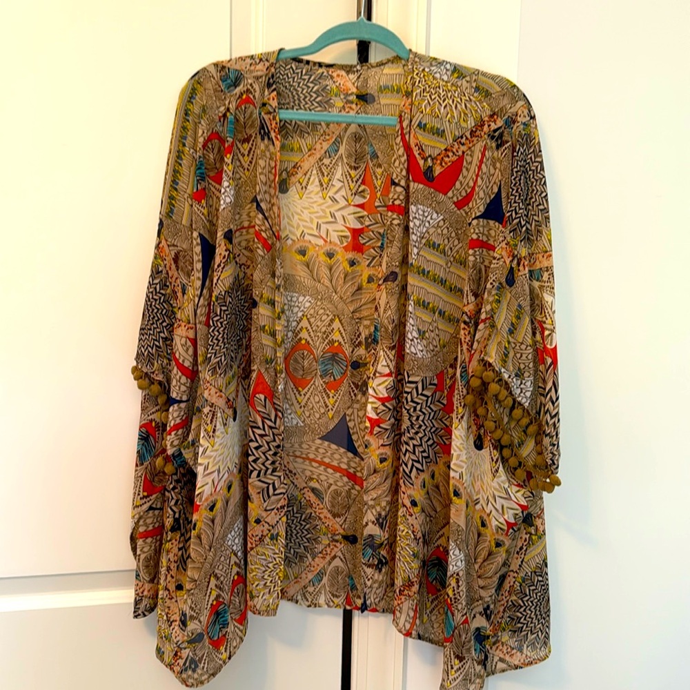 Beautiful sheer cover up cute with T-shirt and jeans or over a bathing suit